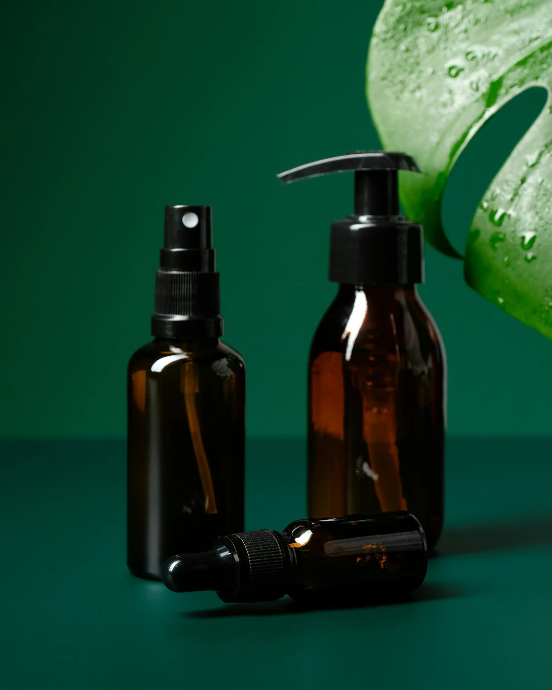 Brown Plastic Bottles On Green Background